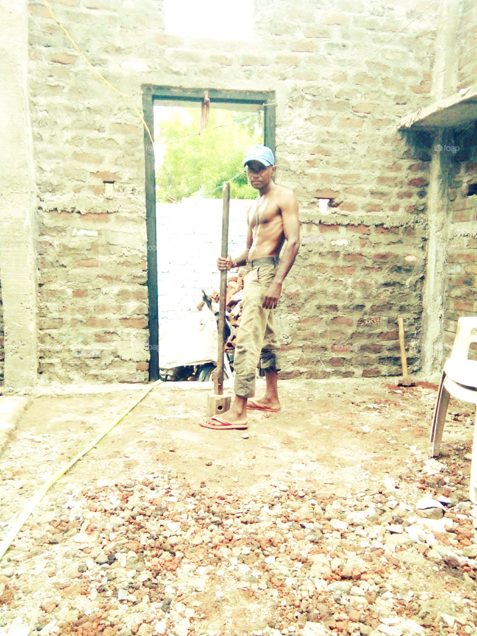 Photographs of a workman,a photo of a real worker,a photo of a man who is on the ground,a photo of a worker,a photo of a worker who work,good and true photos of hard work,a photo of a worker,a photo of an Indian,a worker  That color photos,no.1 photo