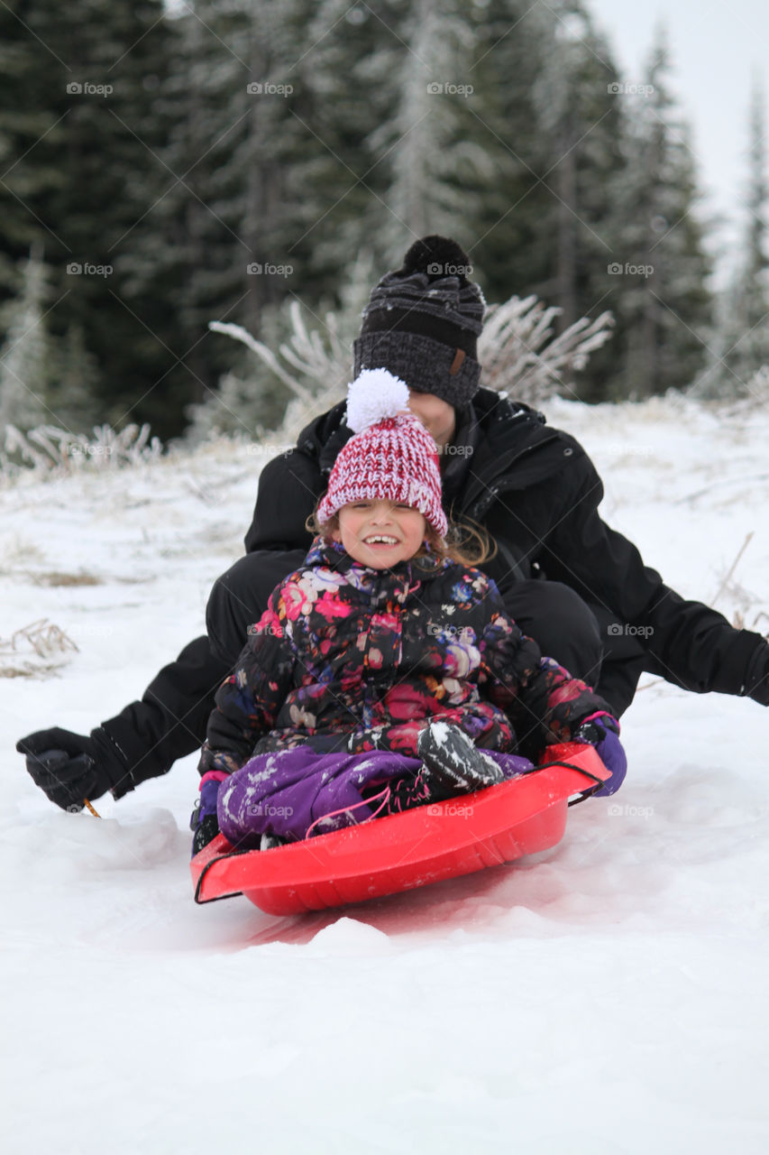 Brother and sister sledding