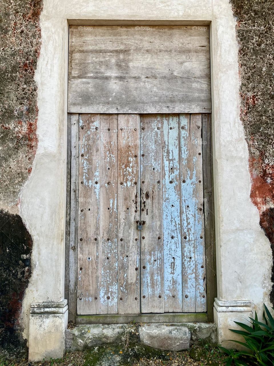 A painted wooden door in an old Spanish hacienda