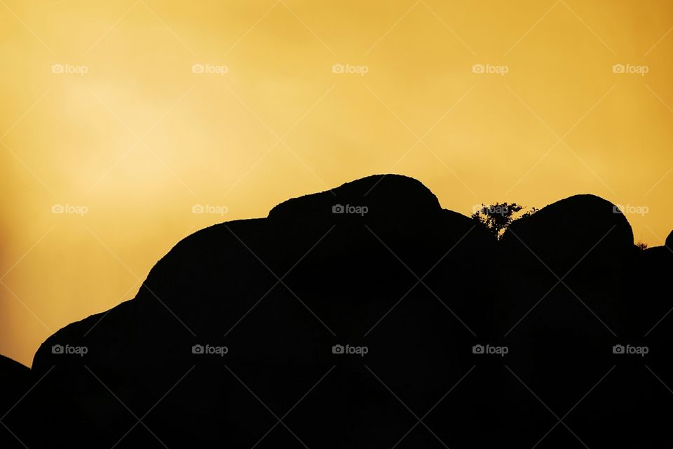 Rocky silhouette in front of a yellow sky