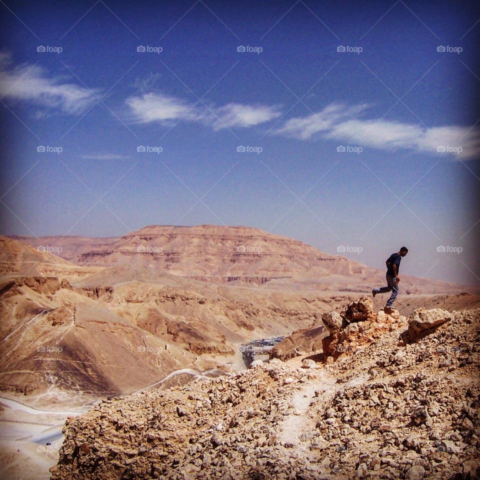 A hiker looked at the Valley of the Kings down below where pharaohs and important nobles were buried. 