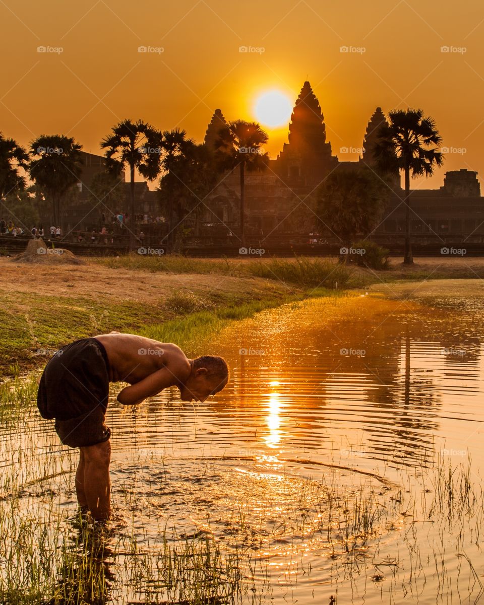 I was shooting sunrise at Angkor Wat when instantly an old man arrive and start shower himself in the pound. Unique moment