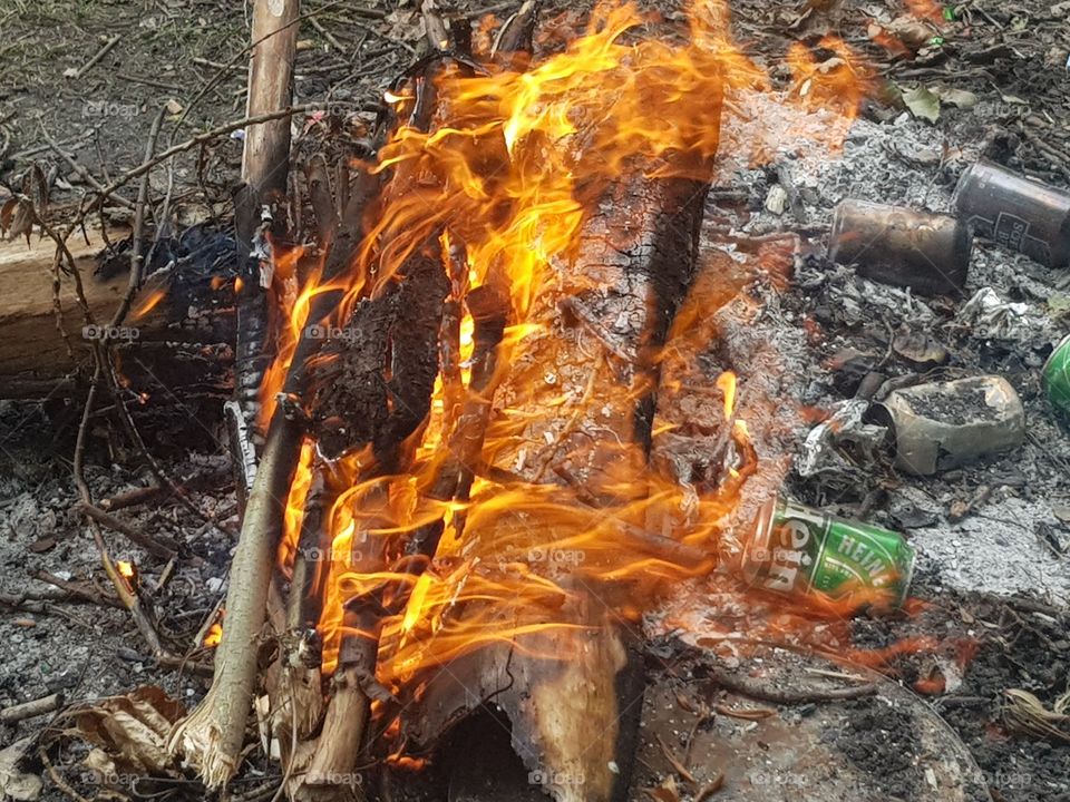Rampant campfire in daylight.