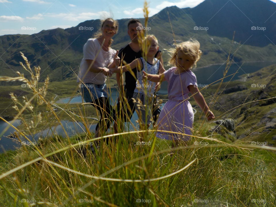 Happy family standing in grass field