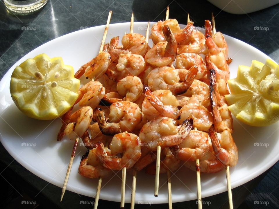 Prawns with skewers on plate