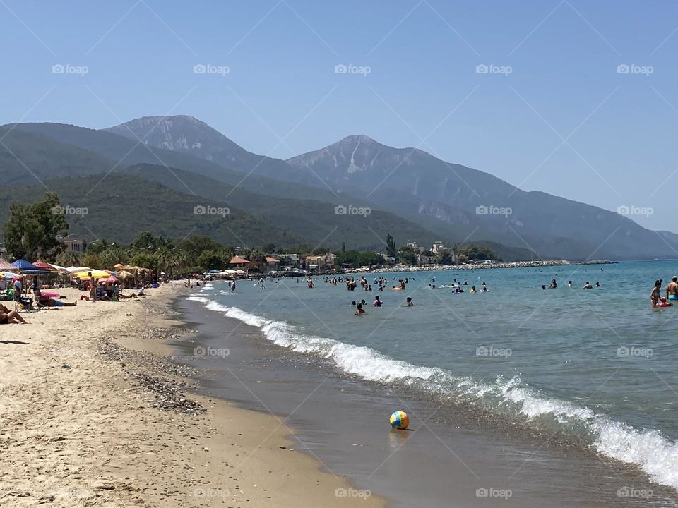 Sunny holidays I’m Turkey. Walk in the cute city and charming streets by the beach in Kusadasi. perfect blue sky and ocean view. Beach and the shore. To travel is to live. Gorgeous tall palm trees.