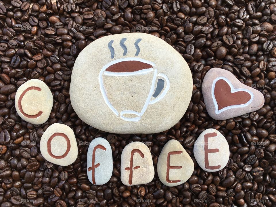 Close-up of coffee text against roasted coffee beans