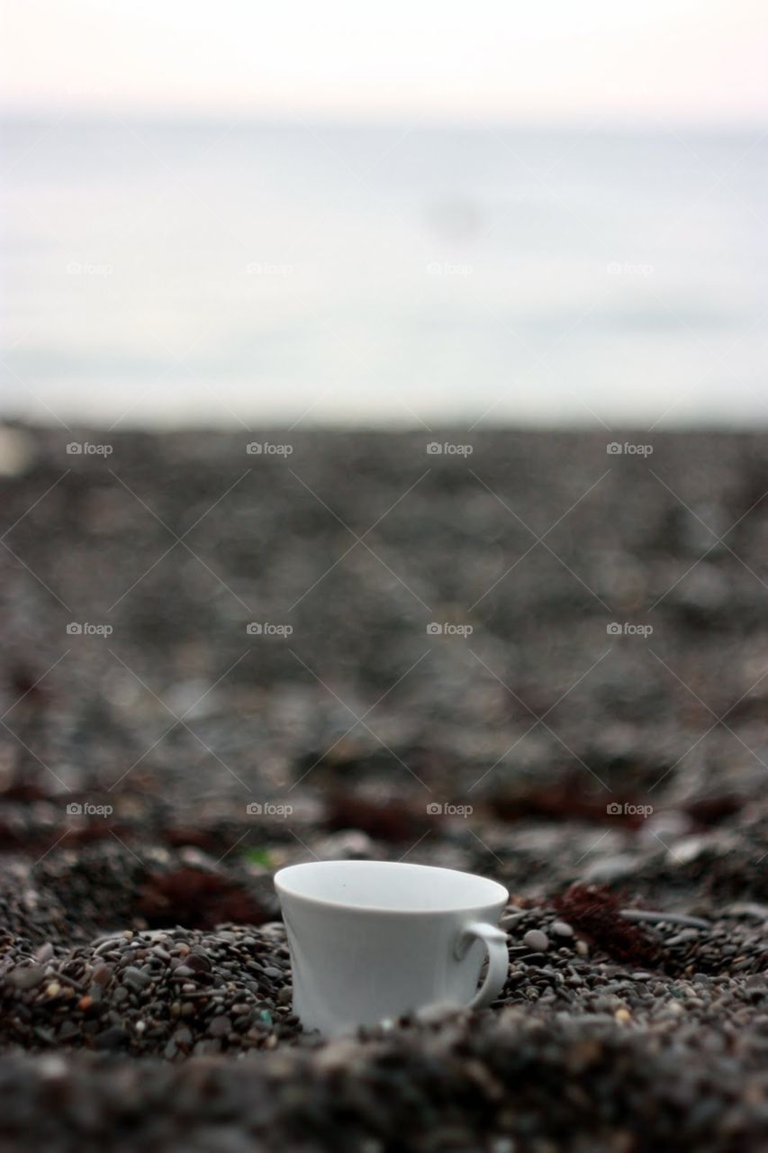 Cup of coffee on the beach