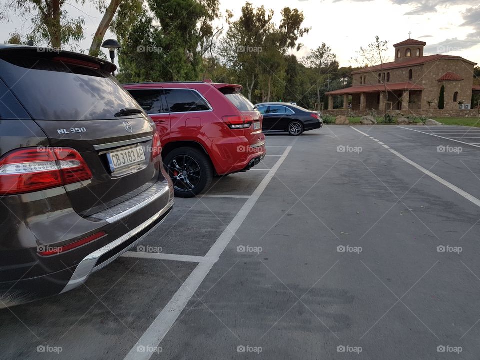 parking lot with luxury and expensive cars