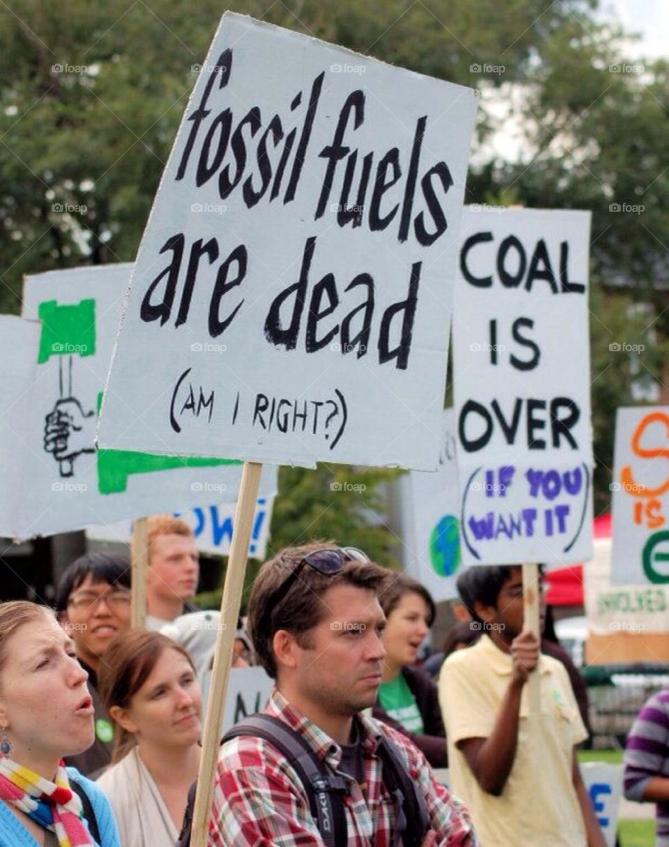 Protest : fossil fuels . Protesters at a gathering in Chicago , against fossil fuels , coal. Environmental concerns , global warming.