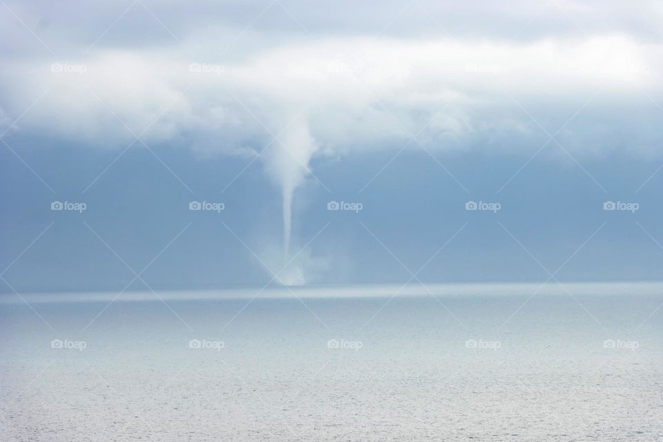 Waterspout, a rotating column of water and spray formed behind a island as result of cold air and warm ses