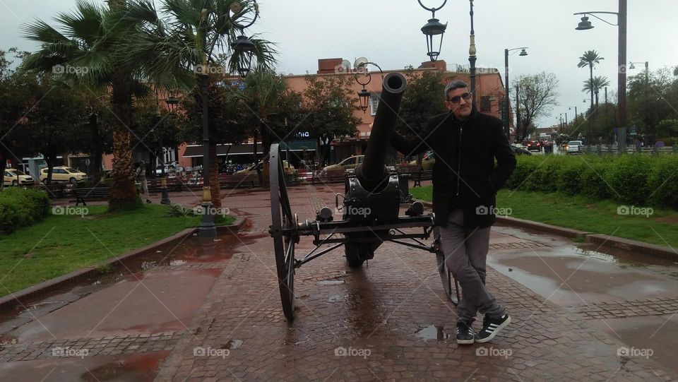 I stand near an old historical cannon.