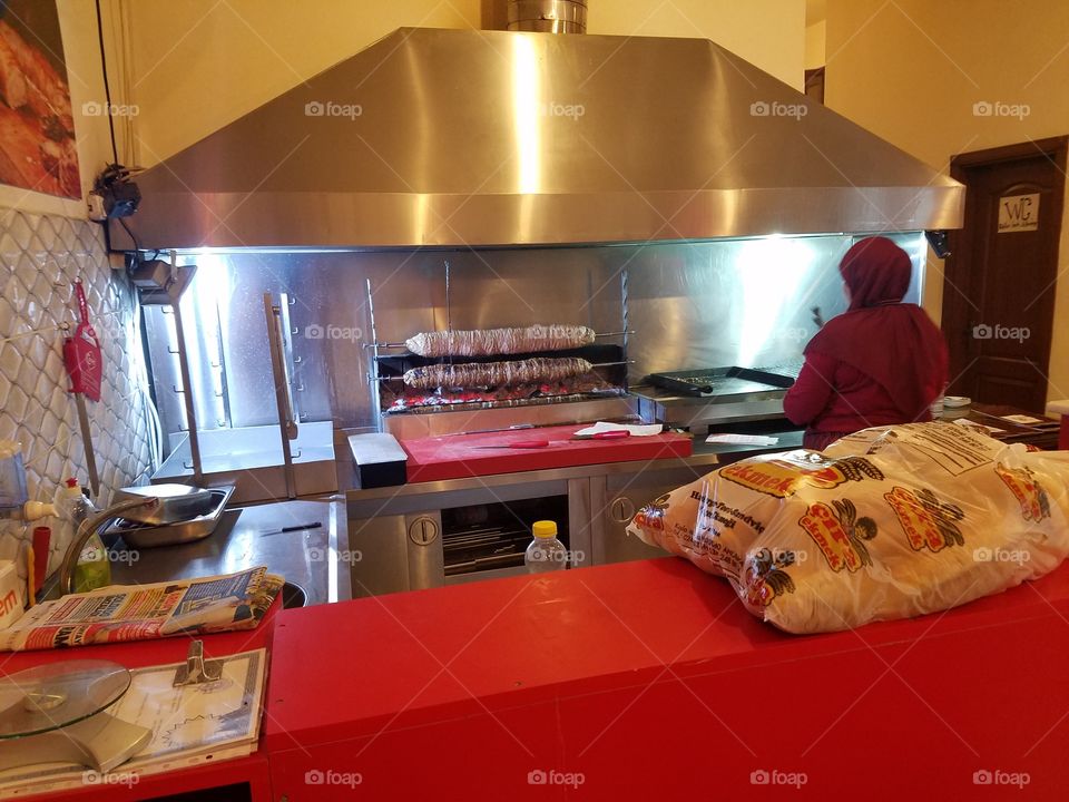 an old turkish woman cooks Kokoreç