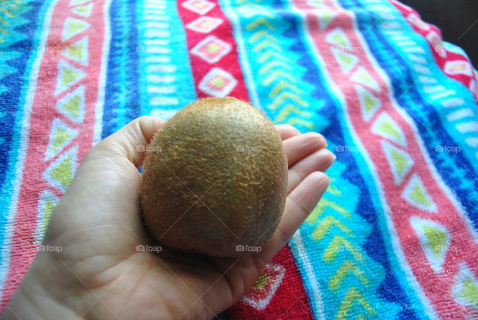 Holding a kiwi