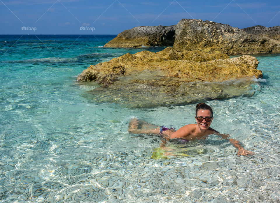 Smiling woman swimming in sea