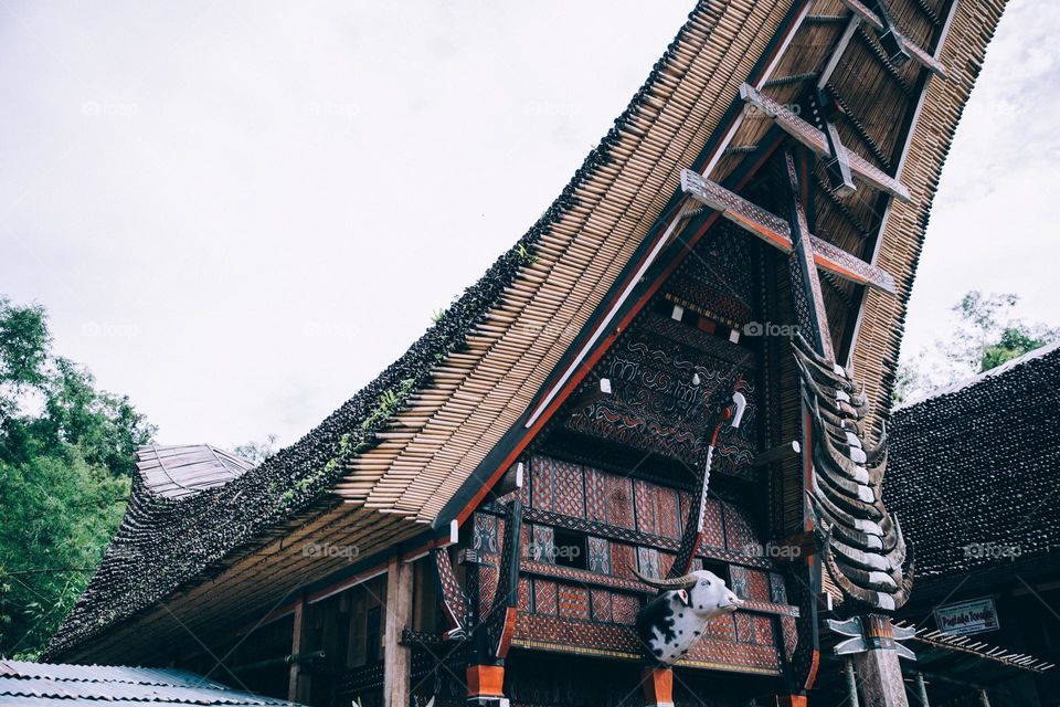 ornate indonesian bamboo temple towers overhead