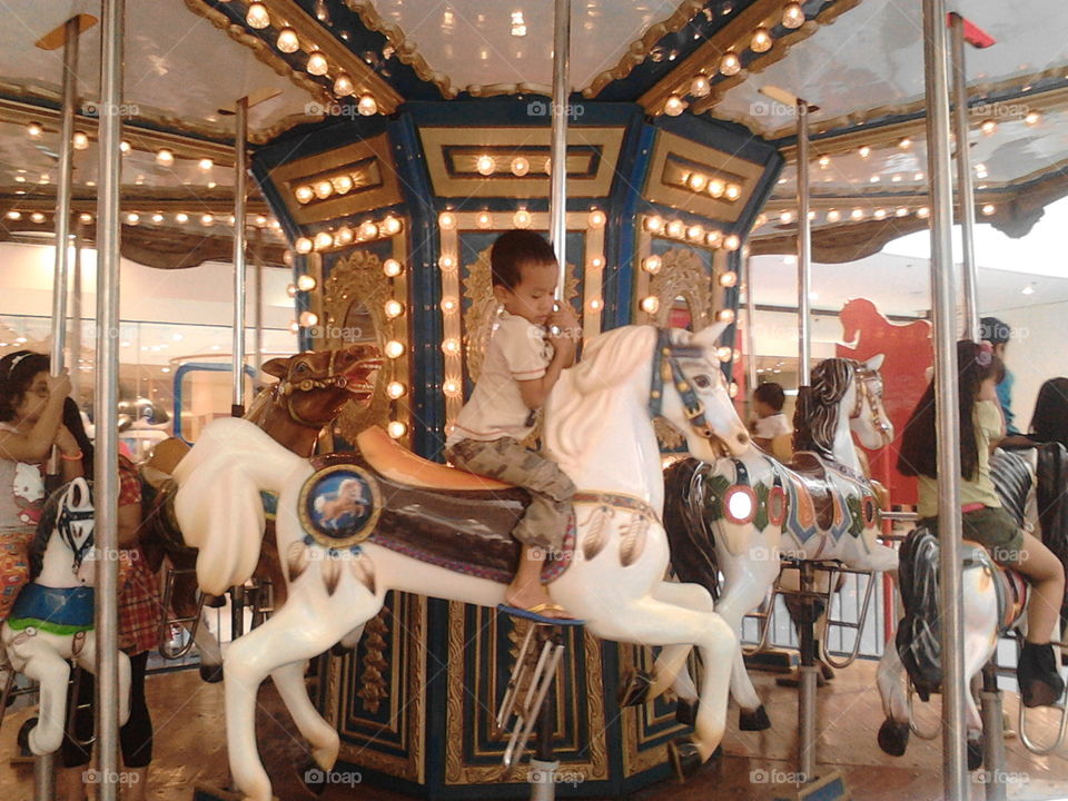 he playing riding a horse in mall of asia