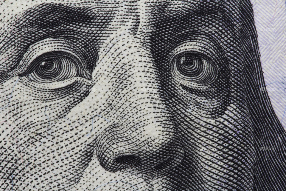 Benjamin Franklin's look on a hundred dollar bill. portrait of the Benjamin Franklin , macro usa dollar banknote or bill. we take money every day,  but don't see all details of banknotes