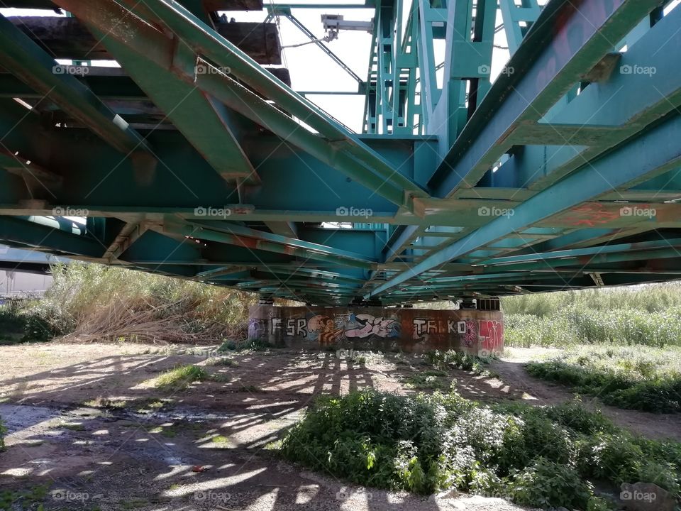 Under the train rail bridge