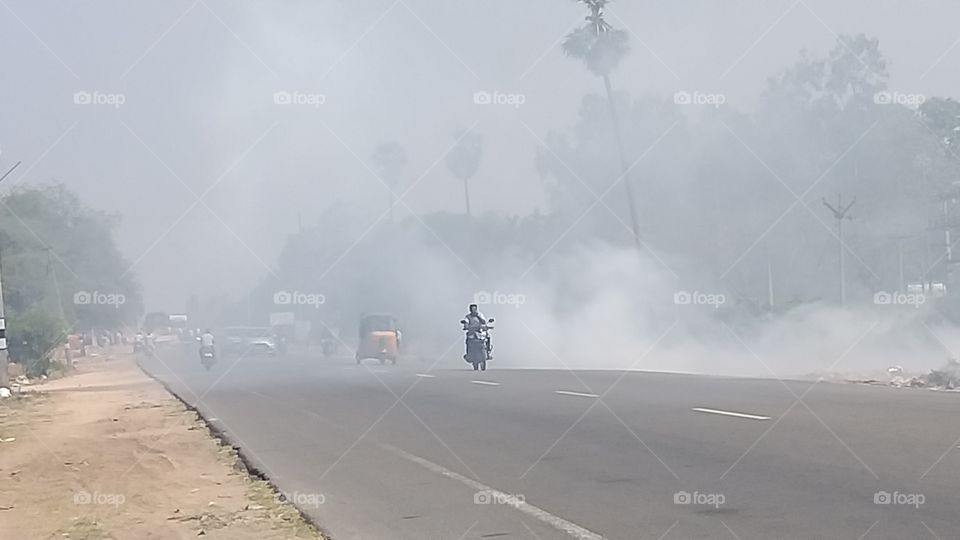 burning waste materials on the roadside.polluting the air and spoiling the environment. perennial problem in the developing countries like india.