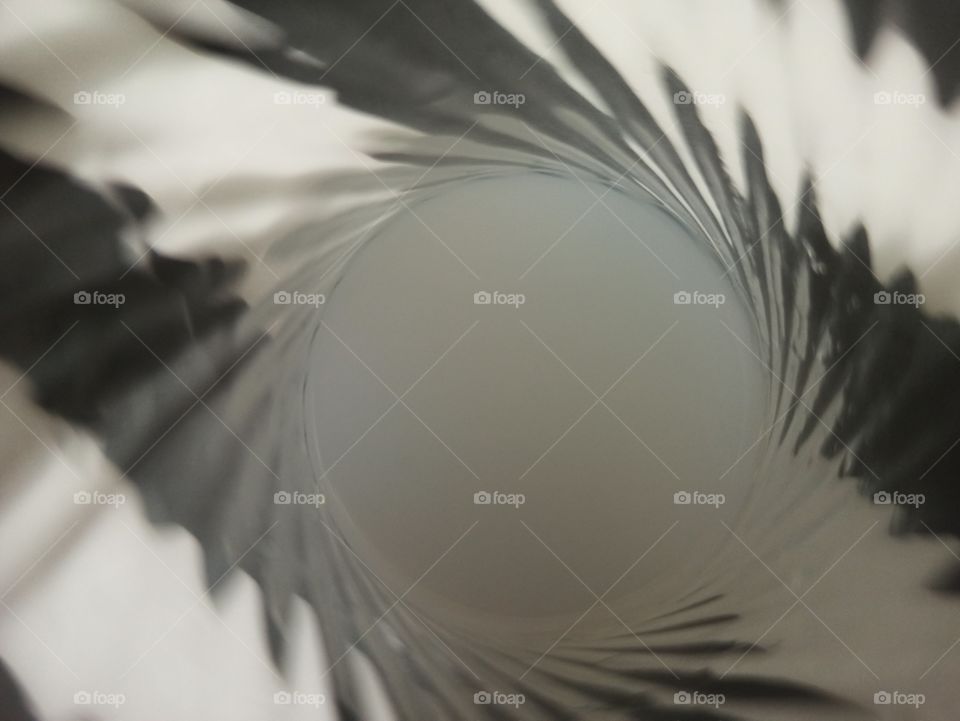 A photo of alcoholic drink in a beautifully shaped glass. With black and white lines background