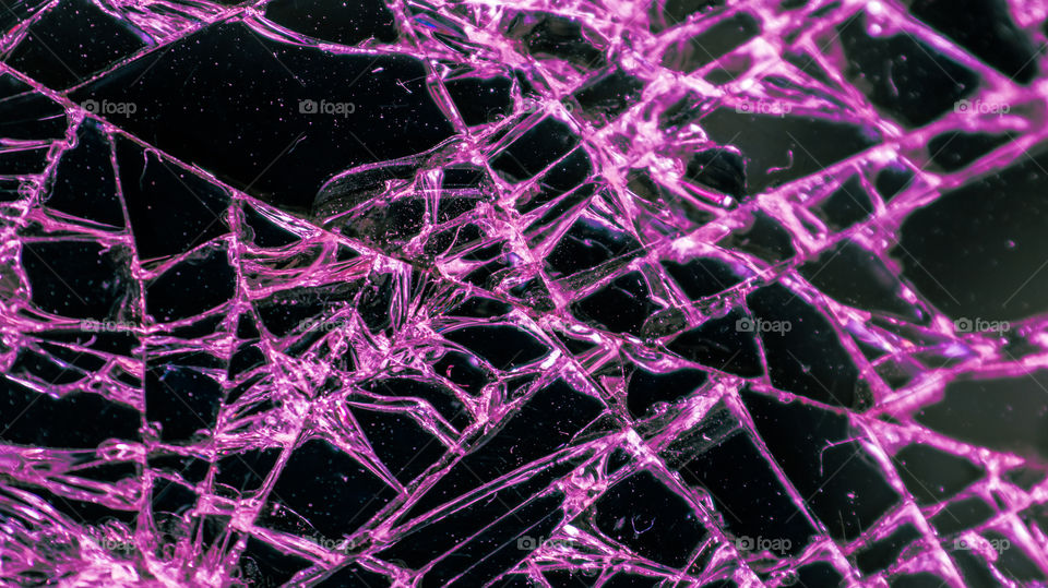 Multi-colored and bright broken smartphone screen close-up.