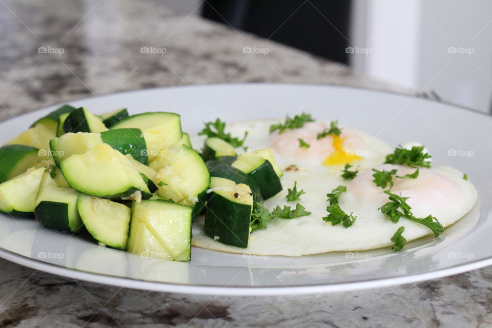 Sunny side eggs with zucchini