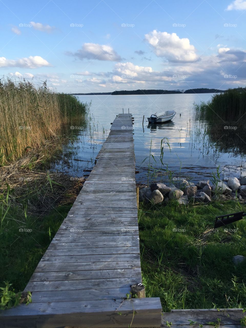Jetty,boat and sea, Sweden . Summer evening view in Kolmården, Sweden