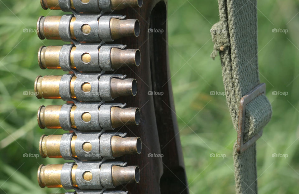 Belt Of Old Bullets On An Stripped Rifle Stock