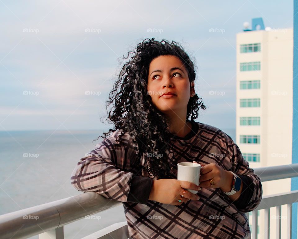 Women in that time of month when they feel alone but making the best out of life. Drinking the first cup of coffee.