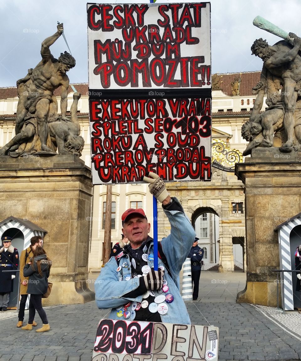 Man standing with hording in front of Prague castle, Bohemia