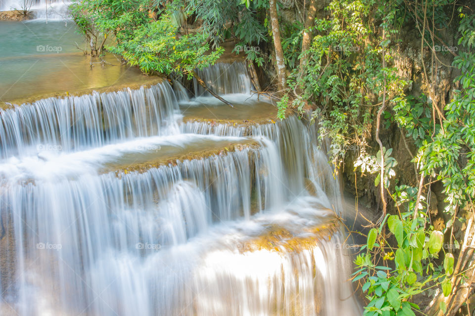 Waterfall flowing from the mountains at Huay Mae khamin waterfall National Park ,Kanchana buri in Thailand.