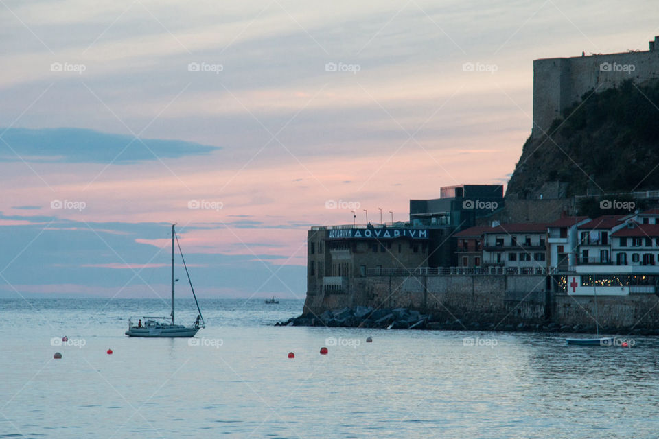 Sailboat in sea during sunset