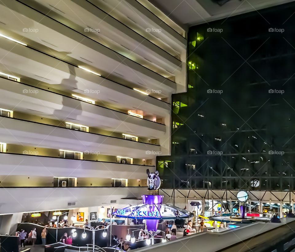 Inside the Contemporary Resort at night.  Below is Chef Mickeys restaurant.  The building is all balconies facing out onto the hotel lobby.  
