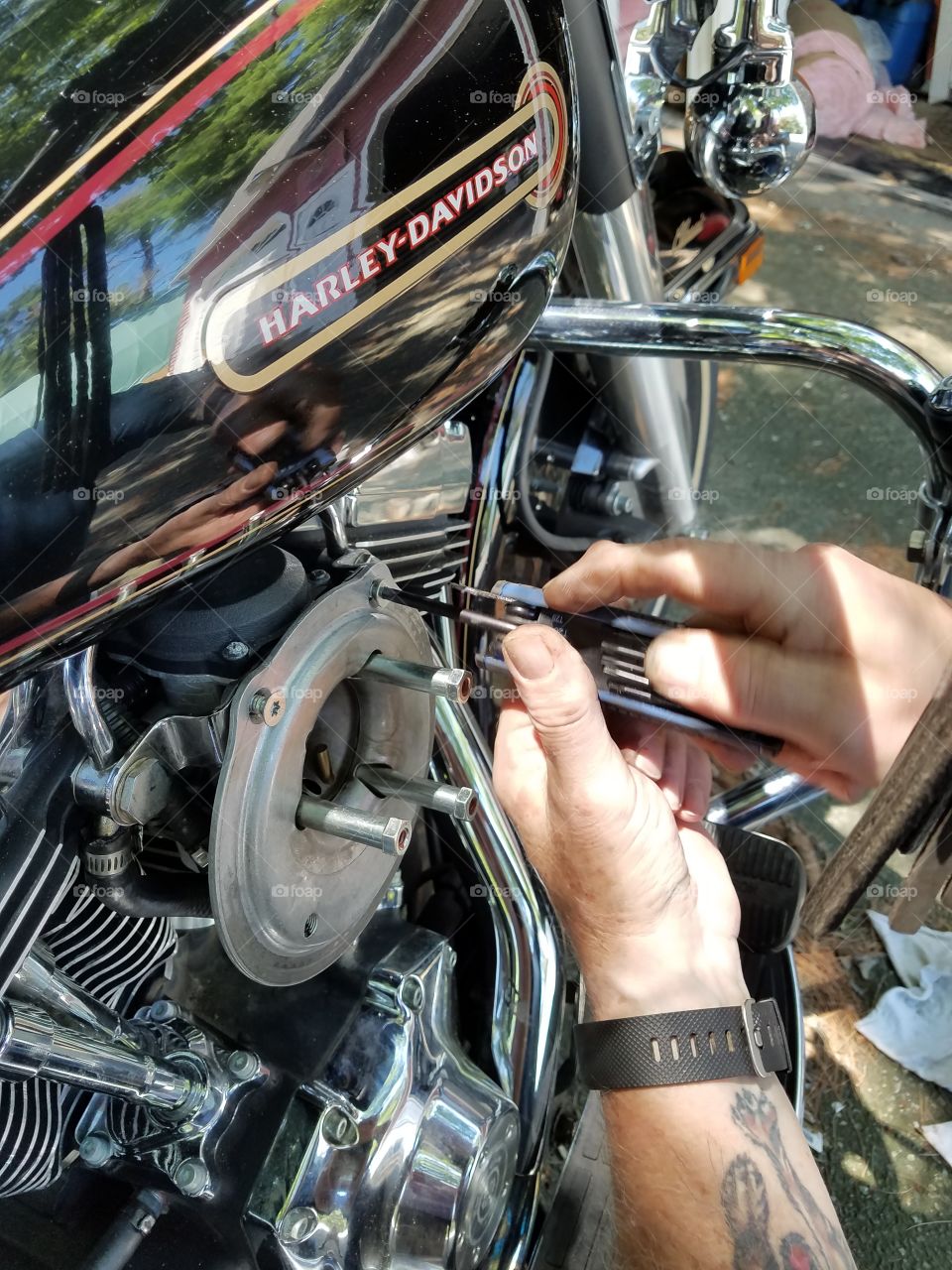 Repairing Harley Davidson gas leak.