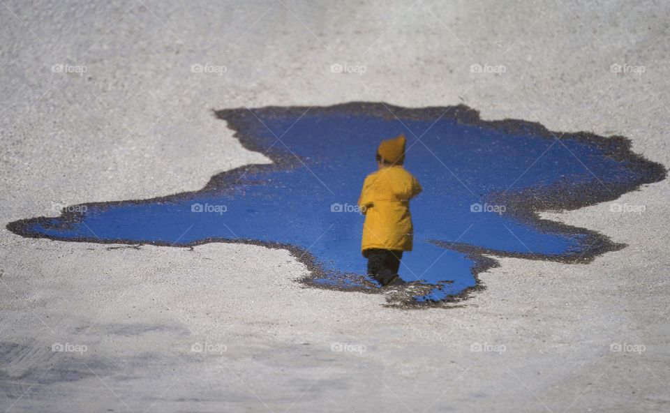 Reflection of a boy in a pool