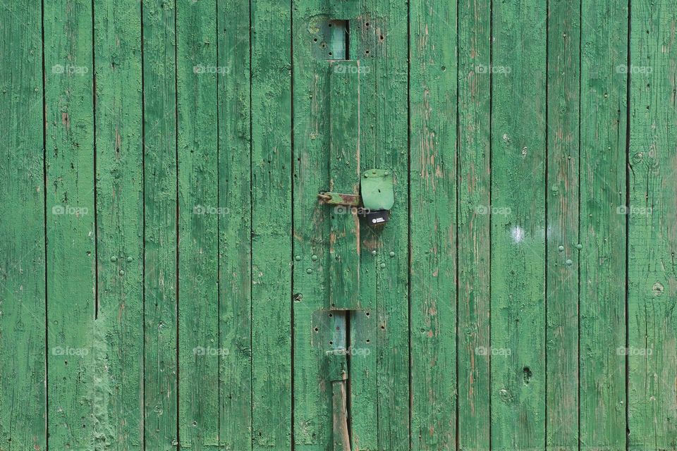 An abstract of an old wooden green garage door in Brooklyn, New York City.
