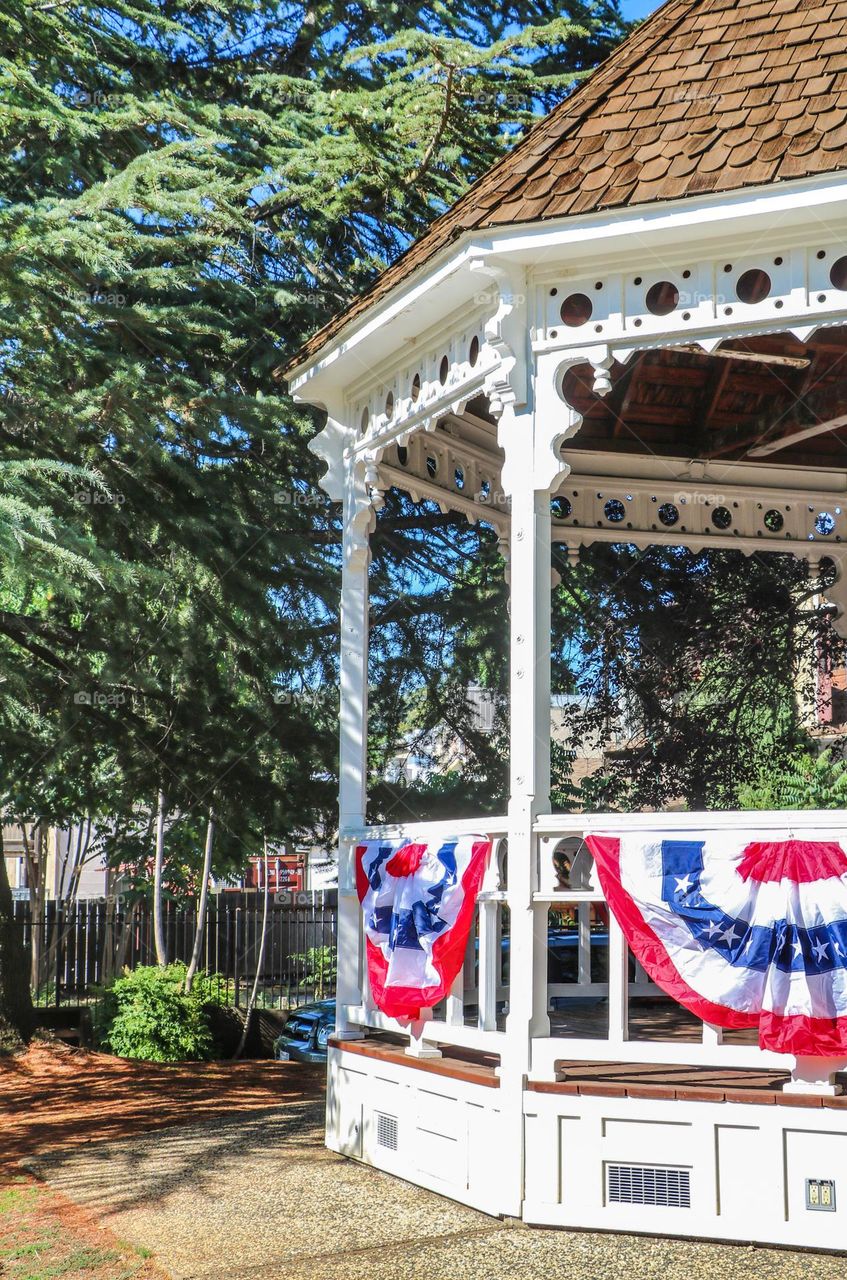 Gazebo in a small town decorated for the Fourth of July with festive American flag bunting 