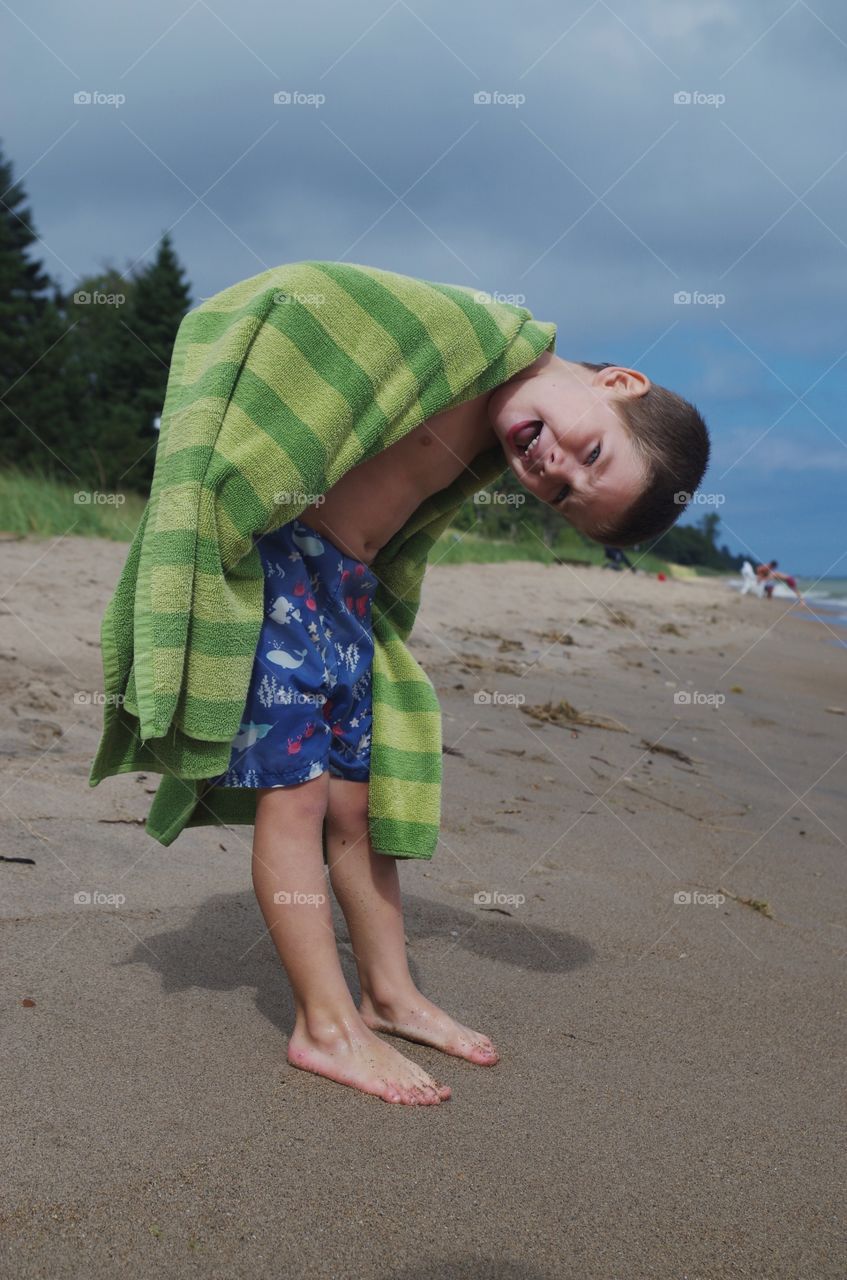 Portrait of small boy on sandy beach