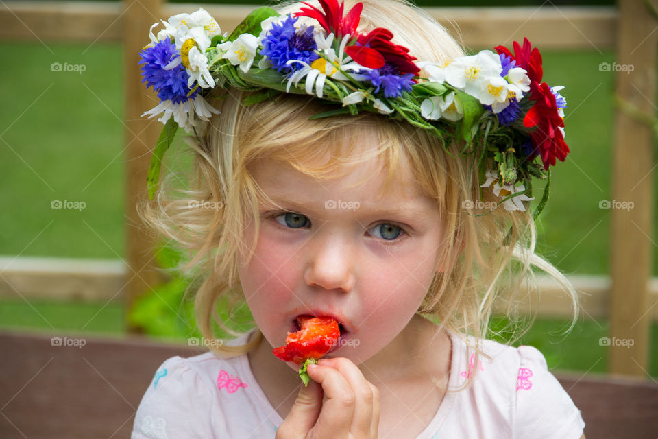 Pretty girl eating strawberry