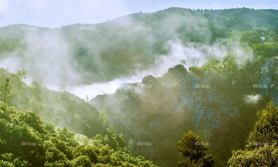 Early morning mist swirls around rocky ridges in Central Portugal 