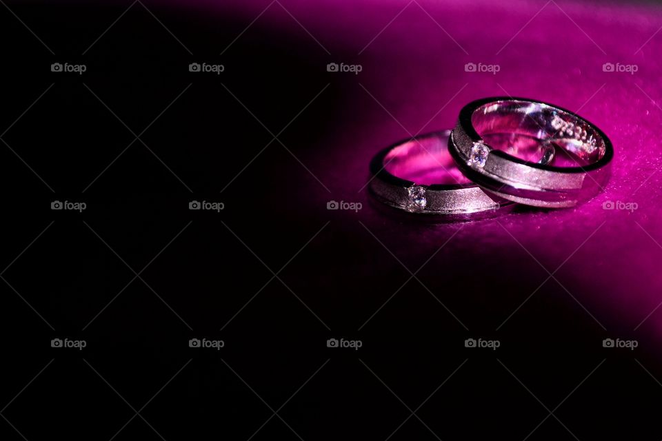 A pair of wedding rings on purple