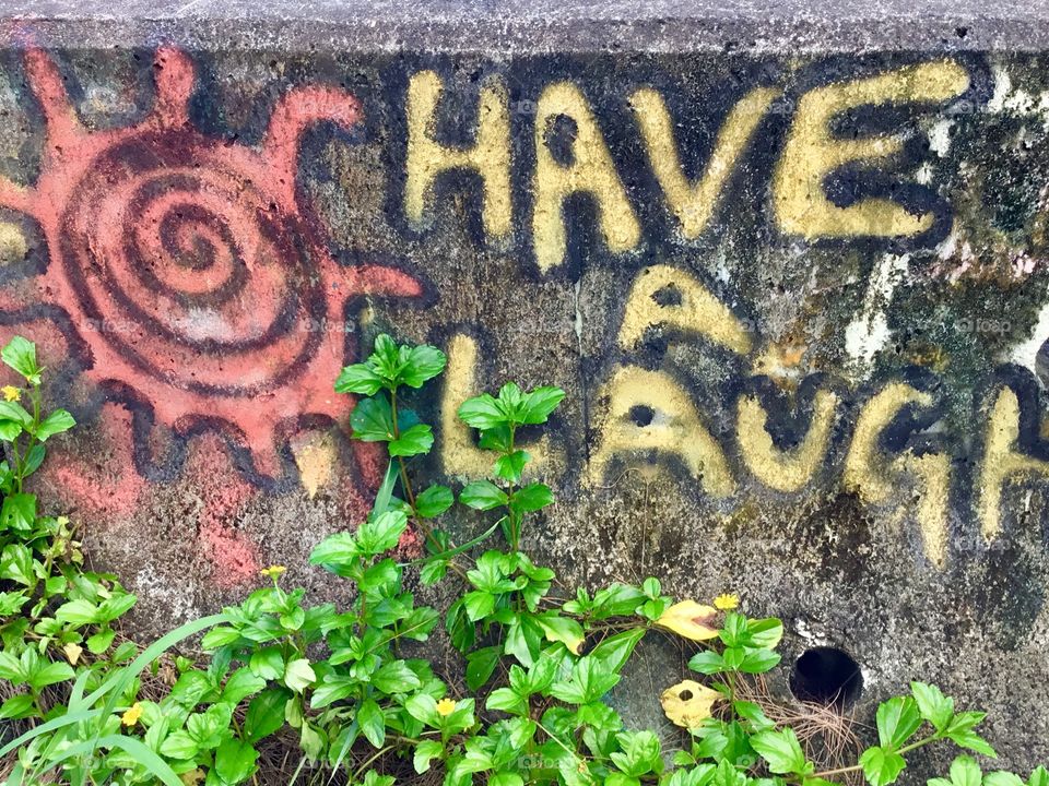 Have a laugh - graffiti by the ocean.