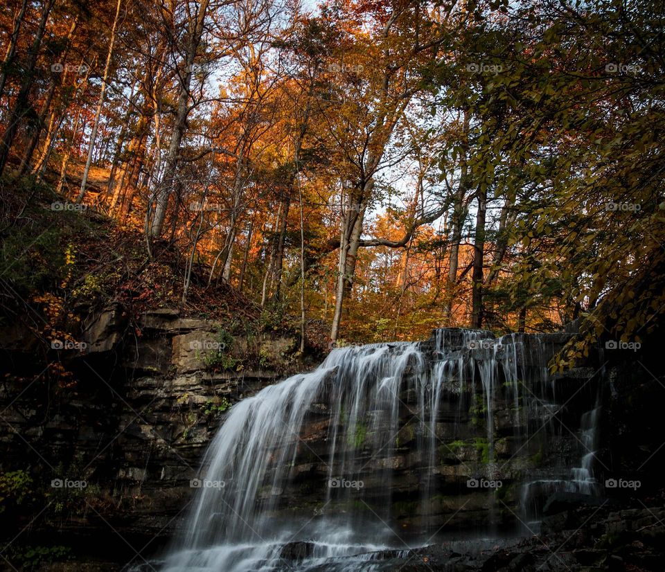 Beautiful small waterfall in autumn forest