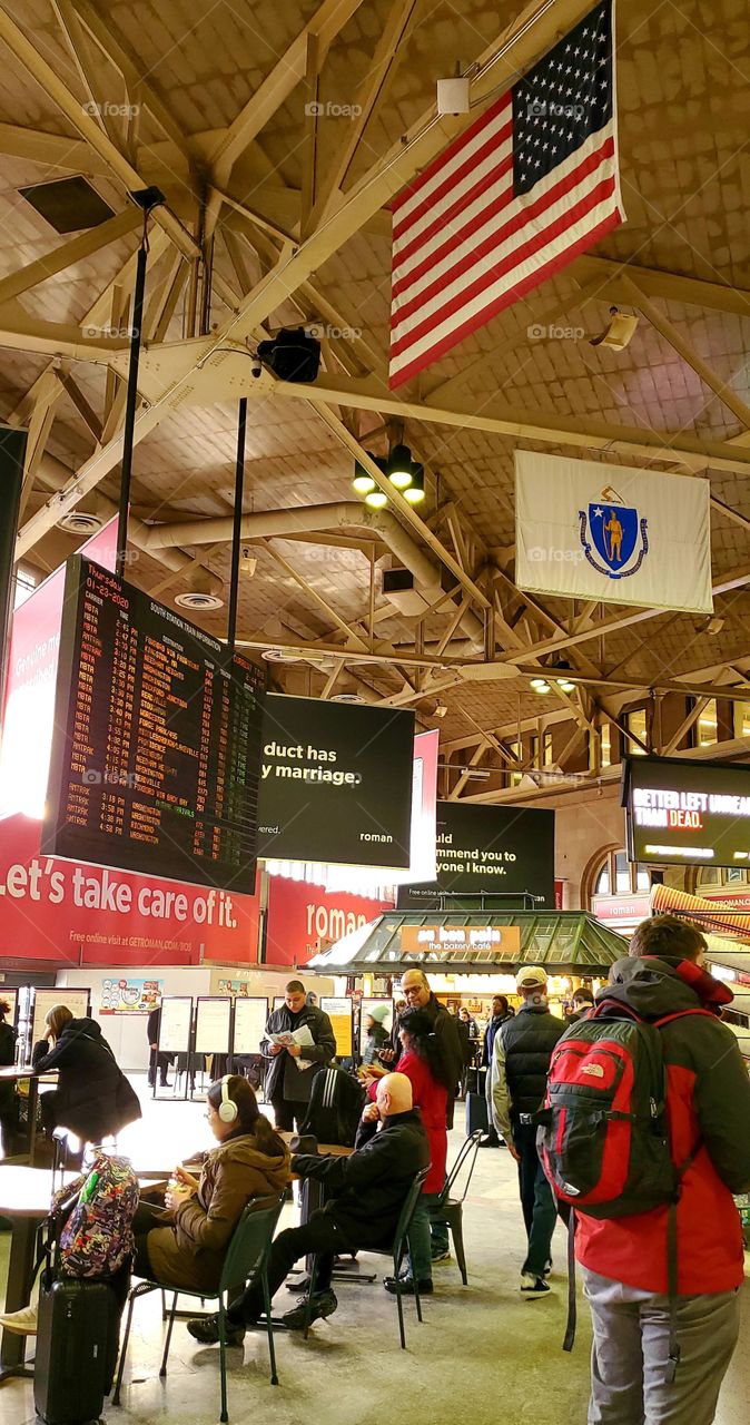 Train Station, South Station in Boston. It's the end of all the train lines. Or the beginning of all the trains going to local & out of state destinations. Keosks, coffee shops, food shops to keep you busy waiting for your train.