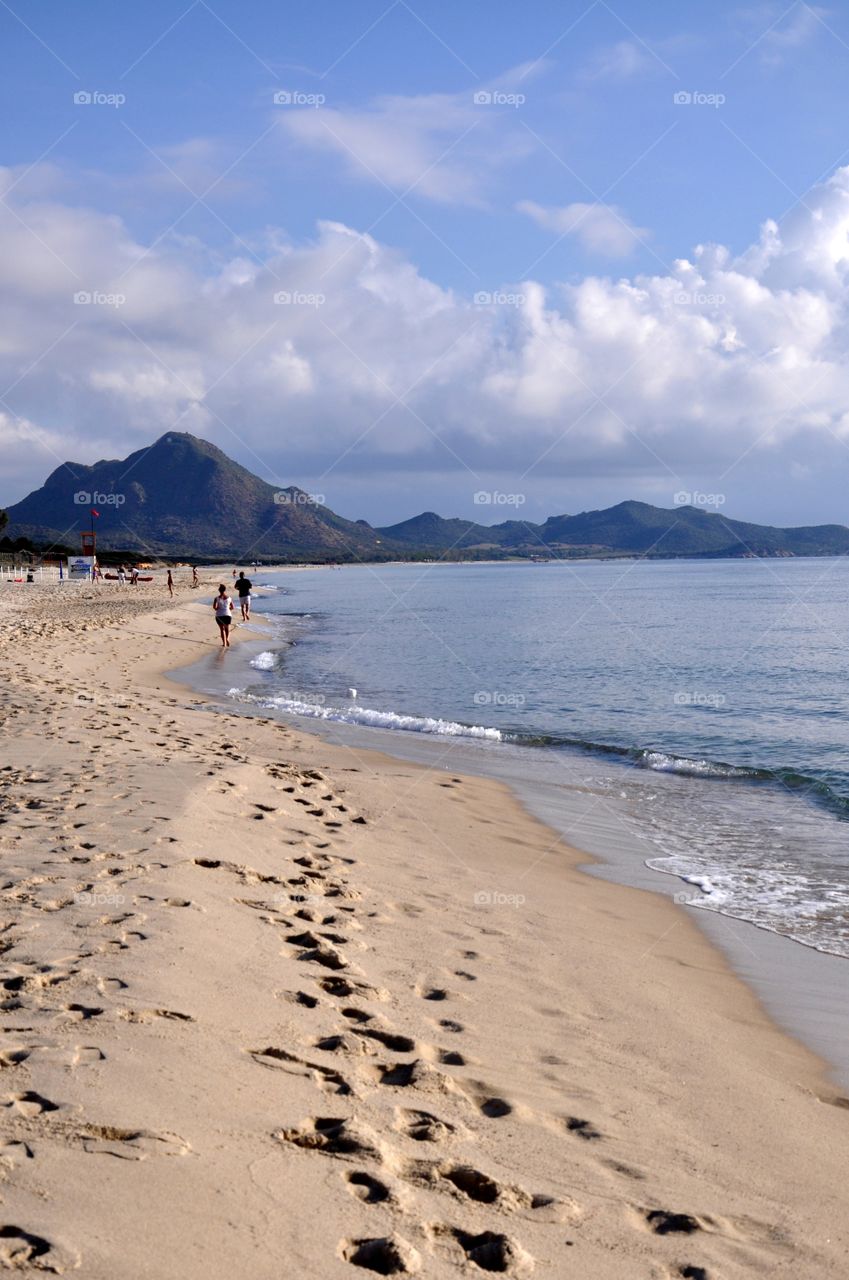 Footprints on the beach Sardinia island Italy 