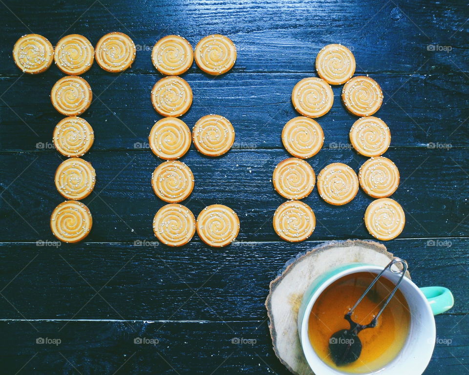 cookies, cup of tea on a black background