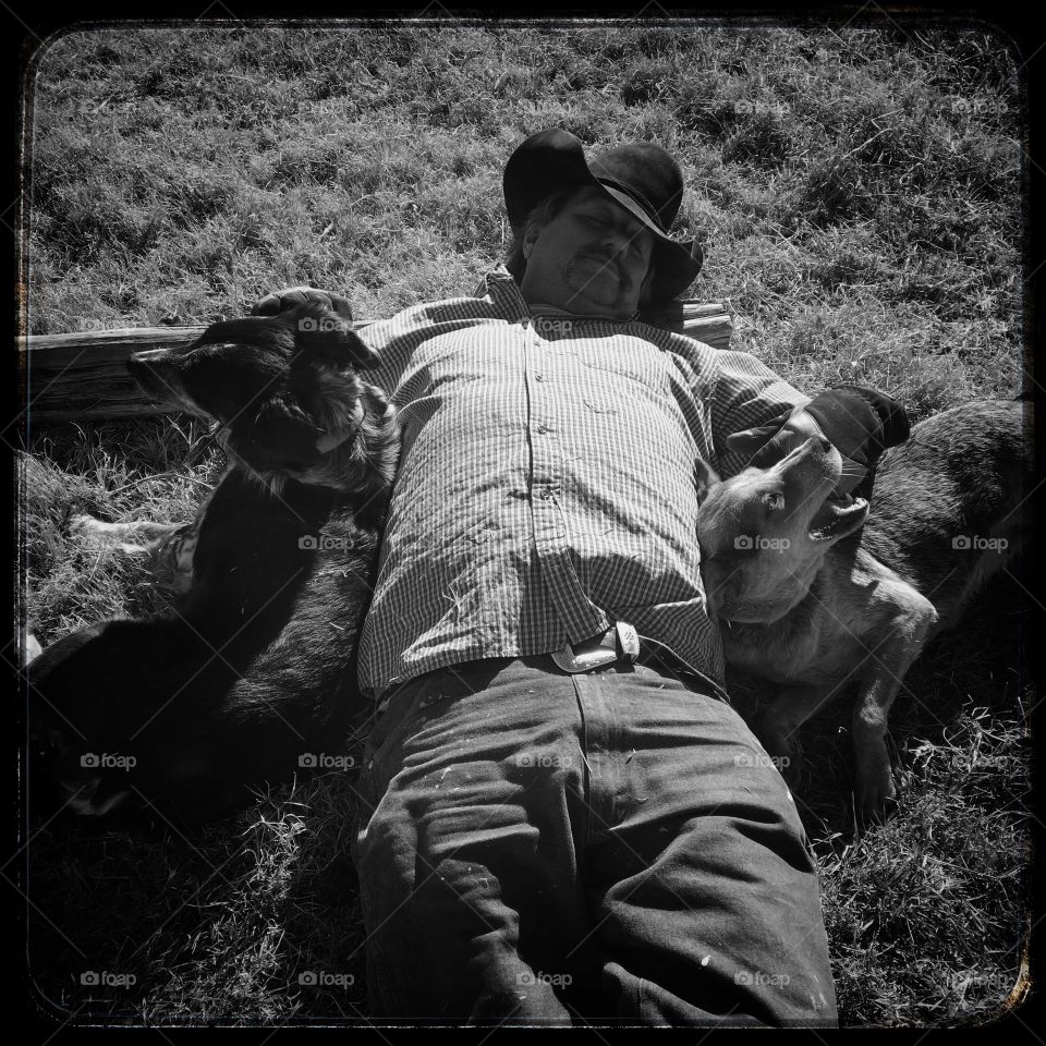 Mature man lying on grass with dog