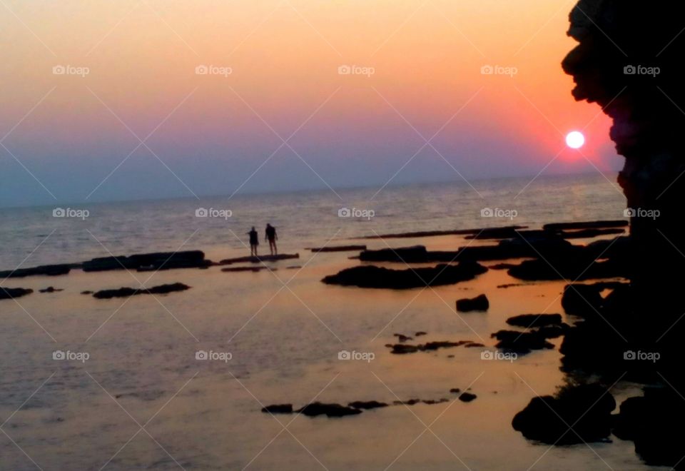 peoples on the sea sunset