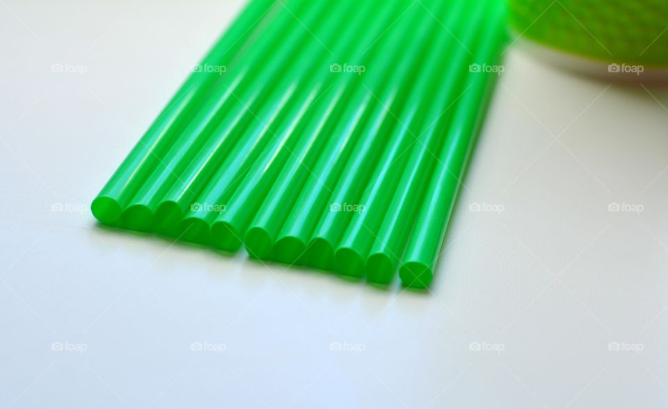 High angle view of green drinking straws